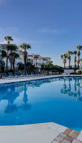 Rooftop deck with Adirondack chairs overlooking Isle of Palms at sunset