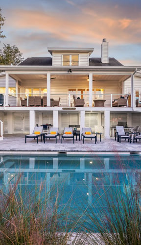 Isle of Palms home with illuminated pool and hot tub at night